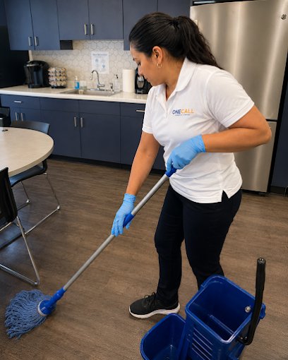 A OneCall crew member mopping an office break room