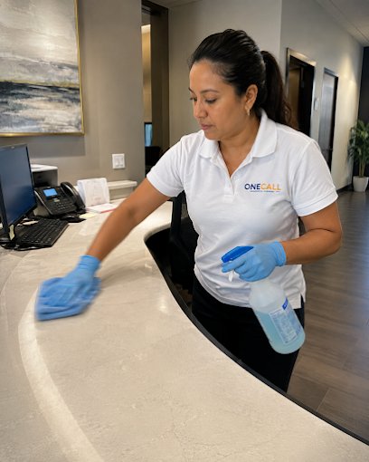 A OneCall crew member wiping down a reception desk
